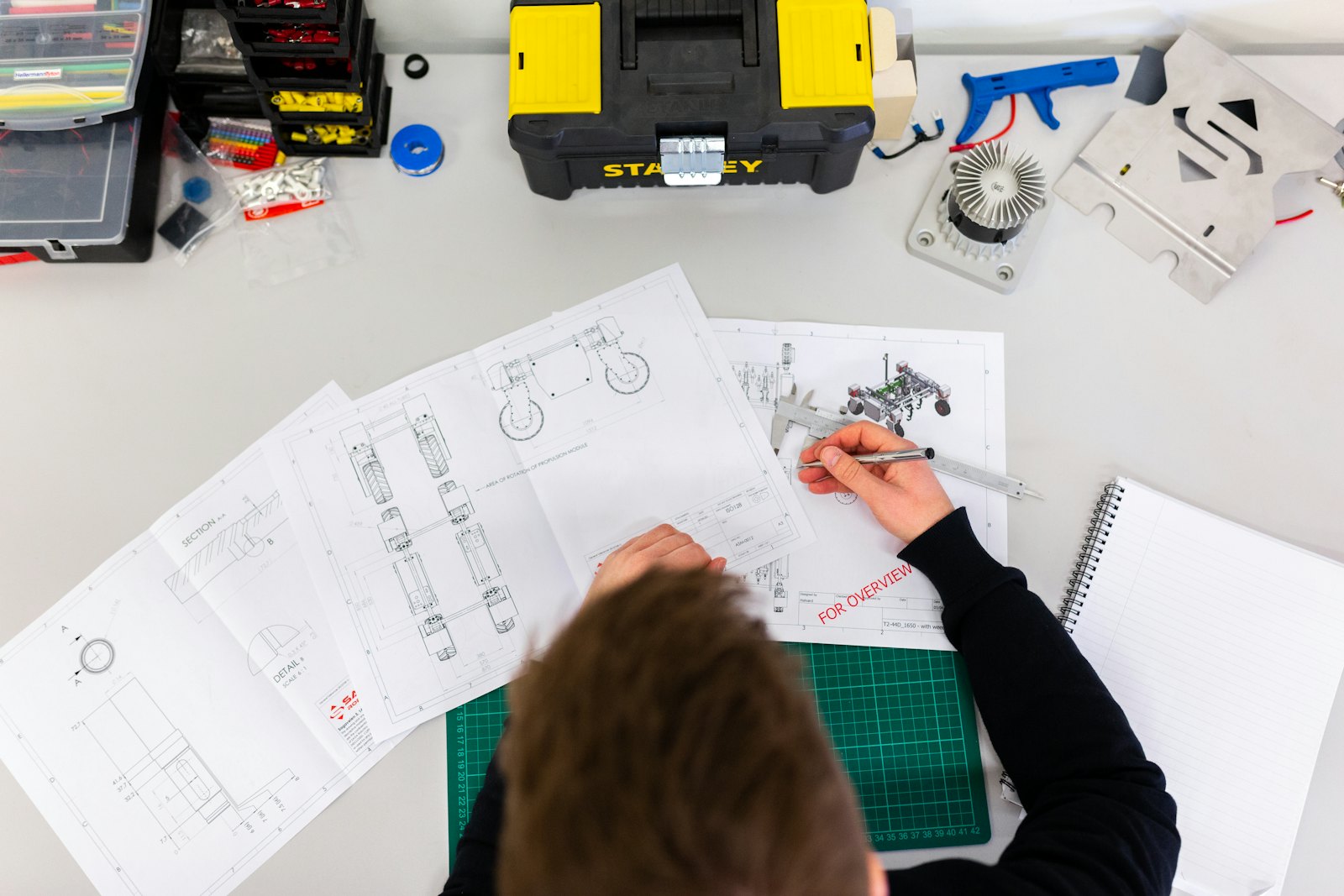Energy professional reviewing building plans and diagnostic tools during a home energy audit