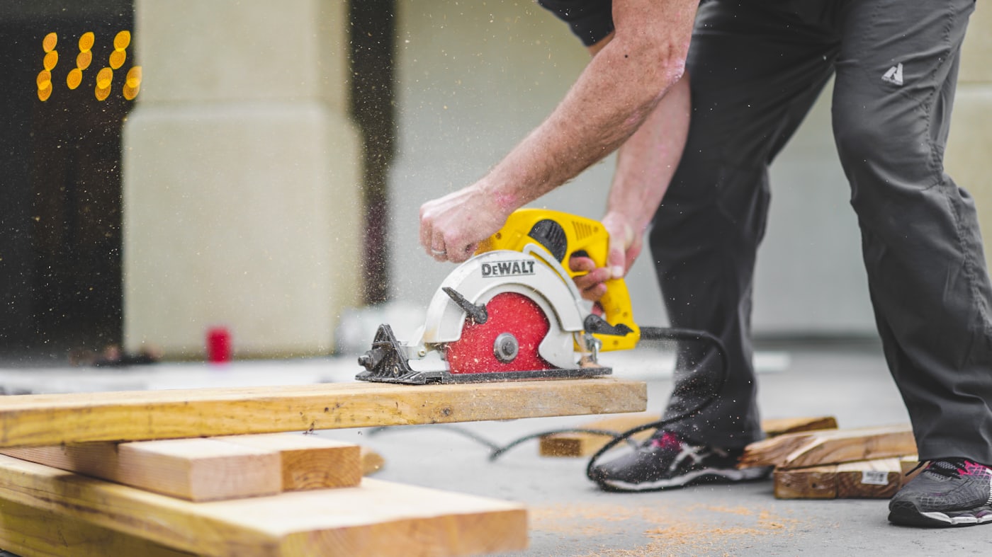 Contractor cutting materials on site during a residential heat pump installation project