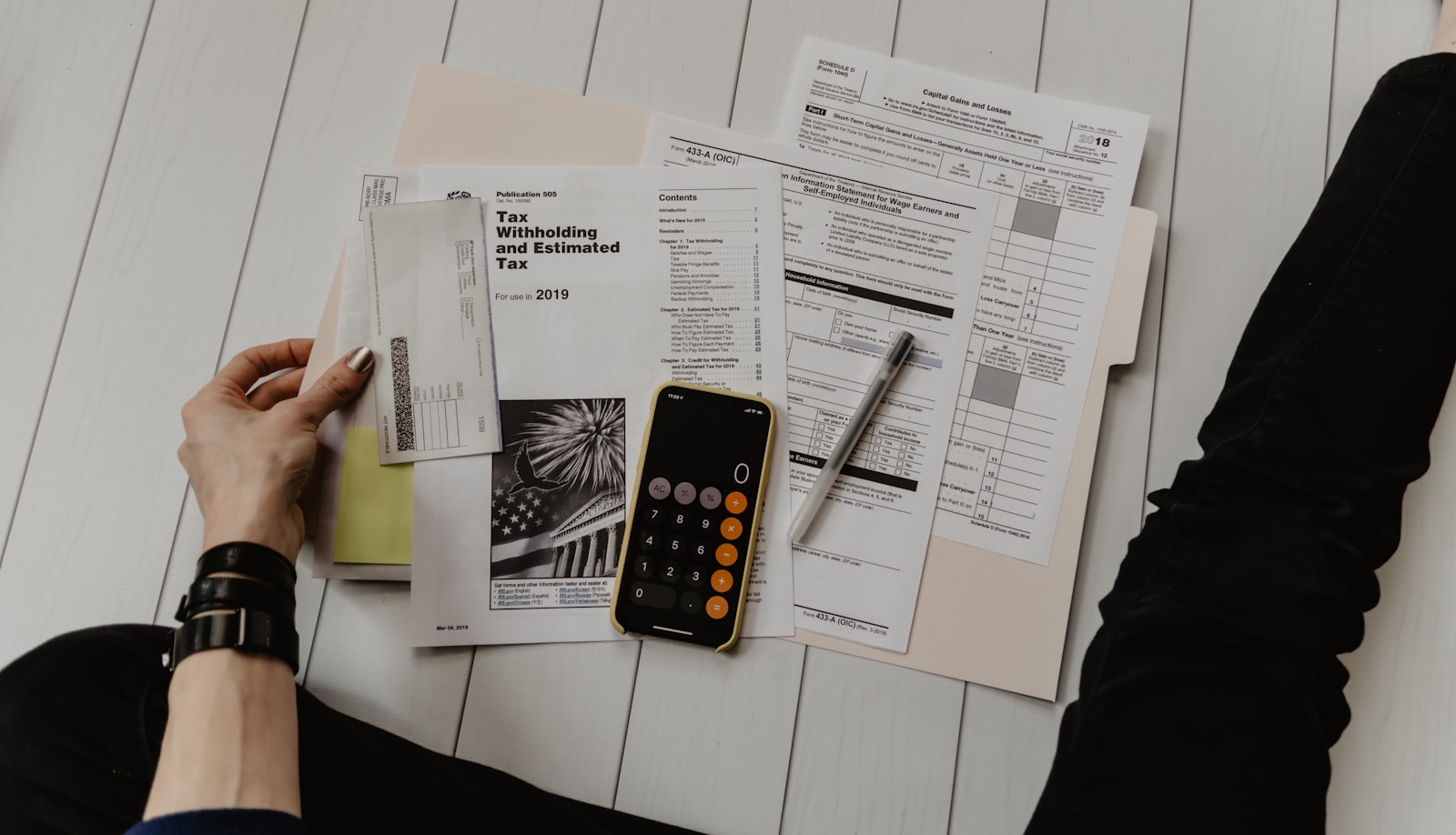 Household budget paperwork and calculator used to check rebate income eligibility